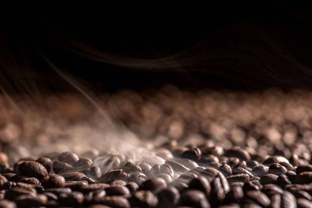 Pile of coffee beans on dark background